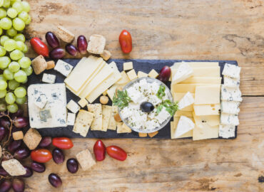 Cheese board featuring cheese, grapes, and assorted fruit